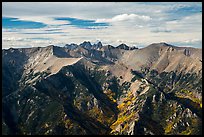 Rocky Sangre de Cristo mountain brightened by aspens in fall foliage. Great Sand Dunes National Park and Preserve, Colorado, USA.