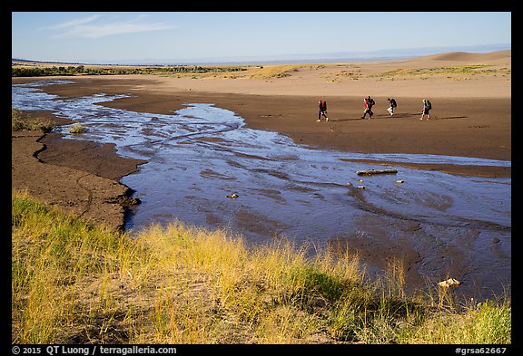 Backpackers hiking out of dunes. Great Sand Dunes National Park and Preserve (color)