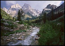 Valley, Cascade creek and Teton range with storm light. Grand Teton National Park, Wyoming, USA.