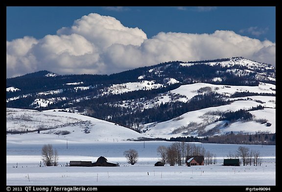 Distant row of barns, hills and clouds in winter. Grand Teton National Park (color)