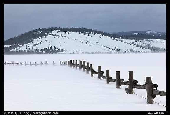 Fence, snowdrift and Ulh Hill. Grand Teton National Park, Wyoming, USA.