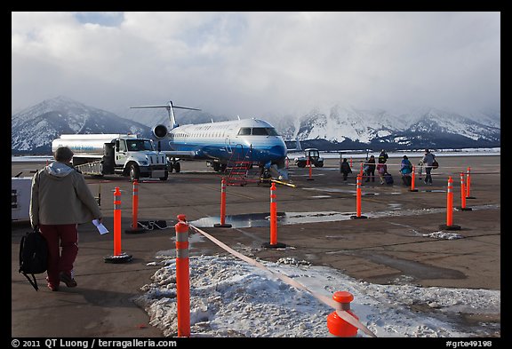 Passengers walking towards plane on Jackson Hole Airport. Grand Teton National Park, Wyoming, USA.