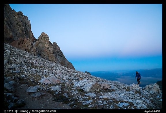 Mountaineer jumps on boulder at Lower Saddle,dusk. Grand Teton National Park (color)