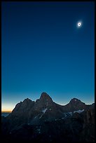 Tetons with eclipsed sun. Grand Teton National Park, Wyoming, USA.