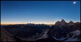 Omnidirectional horizon glow and eclipsed sun over the Tetons. Grand Teton National Park, Wyoming, USA.