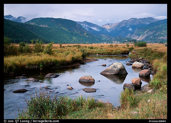 Creek, boulders, and meadow surrounded by mountains, autumn. Rocky Mountain National Park, Colorado, USA.