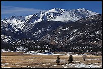 Thawing meadow and snowy peaks, late winter. Rocky Mountain National Park, Colorado, USA.