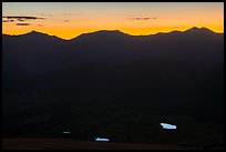 Alpine lakes reflecting the sky below mountain ridges at sunset. Rocky Mountain National Park, Colorado, USA.