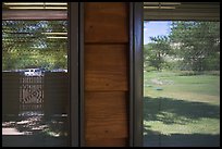 Meadow and parking lot, Medora Visitor Center window reflexion. Theodore Roosevelt National Park, North Dakota, USA. (color)