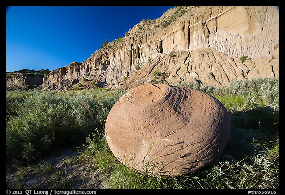 Cannonball in grasses at the base of cliff. Theodore Roosevelt National Park, North Dakota, USA.