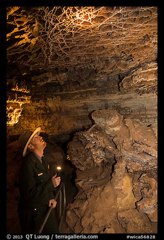 Ranger lights up boxwork in the Elks Room. Wind Cave National Park, South Dakota, USA.