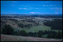 Rolling hills with distant lightening storm at dusk. Wind Cave National Park, South Dakota, USA. (color)