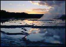 Great Fountain Geyser with residual steam at sunset. Yellowstone National Park, Wyoming, USA.