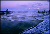 West Thumb Geyser Basin covered by snow at dusk. Yellowstone National Park, Wyoming, USA.