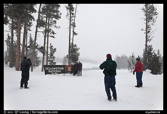 Tourists take pictures with entrance sign in winter. Yellowstone National Park (color)
