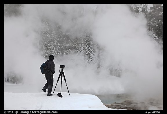 Photographer standing next to hot springs. Yellowstone National Park, Wyoming, USA.