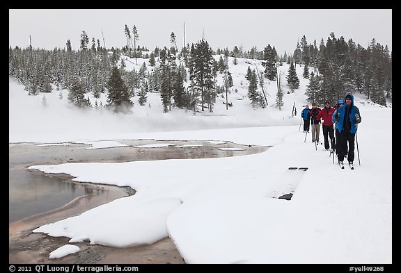 Cross country skiers pass Chromatic Spring. Yellowstone National Park, Wyoming, USA.