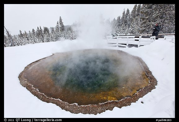 Hiker at Morning Glory Pool, winter. Yellowstone National Park, Wyoming, USA.