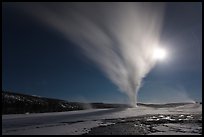 Old Faithful Geyser erupts at night. Yellowstone National Park, Wyoming, USA.