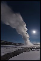 Night view of Old Faithful Geyser in winter with full moon. Yellowstone National Park, Wyoming, USA. (color)