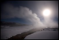 Run-off and geyser, steam obscuring moon, Old Faithful. Yellowstone National Park, Wyoming, USA.