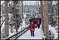 Tourists on boardwalk in winter. Yellowstone National Park, Wyoming, USA.