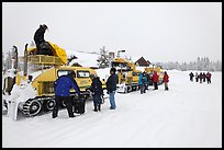 Bombardier snow busses being unloaded at Flagg Ranch. Yellowstone National Park, Wyoming, USA.