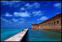 Tourists stroll on the seawall. Dry Tortugas National Park, Florida, USA. (color)