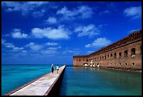 Tourists stroll on the seawall. Dry Tortugas National Park, Florida, USA.