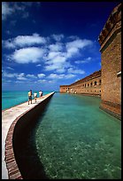 Tourists walking on seawall. Dry Tortugas National Park, Florida, USA.