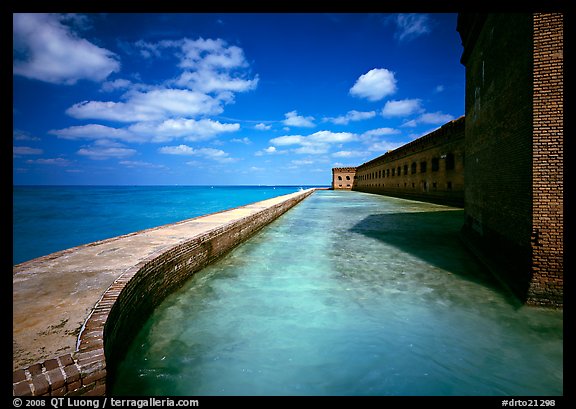 Moat with turquoise waters, seawall, and fort. Dry Tortugas National Park, Florida, USA.