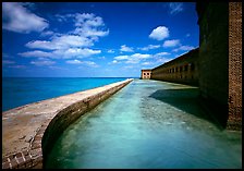 Moat with turquoise waters, seawall, and fort. Dry Tortugas National Park, Florida, USA. (color)