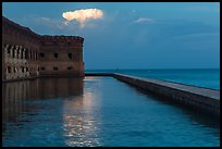 Moat, fort, bright cloud at dawn. Dry Tortugas National Park, Florida, USA. (color)