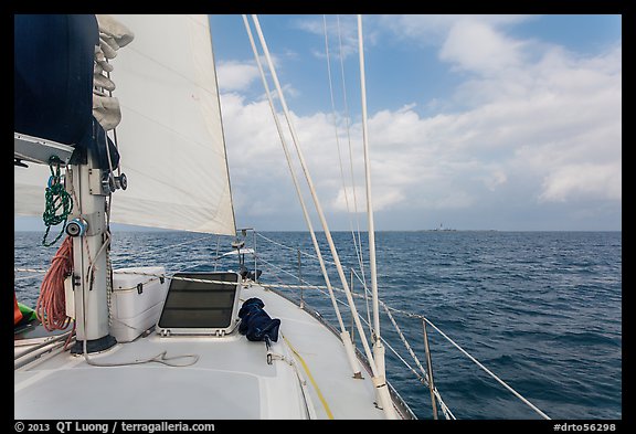 Loggerhead lighthouse seen from sailboat under blue skies. Dry Tortugas National Park (color)