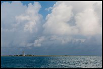 Loggerhead key and lighthouse under tropical clouds. Dry Tortugas National Park, Florida, USA. (color)