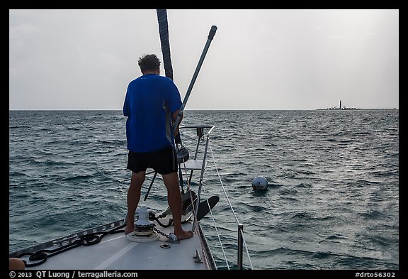 Sailor getting ready to hook mooring buoy near Loggerhead Key. Dry Tortugas National Park (color)