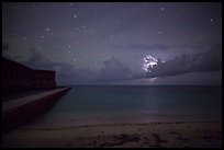 Fort Jefferson and beach at night with cloud electric storm. Dry Tortugas National Park, Florida, USA.