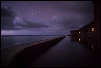 Fort Jefferson at night with stars and light from storm. Dry Tortugas National Park, Florida, USA.