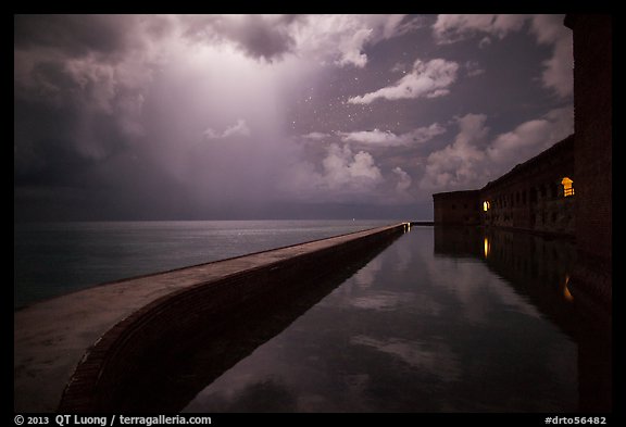 Fort Jefferson seawall at night with sky lit by tropical storm. Dry Tortugas National Park (color)
