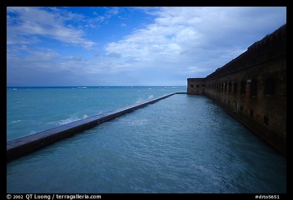 Seascape with fort seawall and moat on cloudy day. Dry Tortugas National Park, Florida, USA.