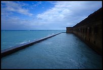Seascape with fort seawall and moat on cloudy day. Dry Tortugas National Park, Florida, USA. (color)