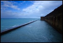 Seascape with fort seawall and moat on cloudy day. Dry Tortugas National Park, Florida, USA. (color)