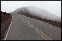 Summit road in fog, Haleakala crater. Haleakala National Park, Hawaii, USA.