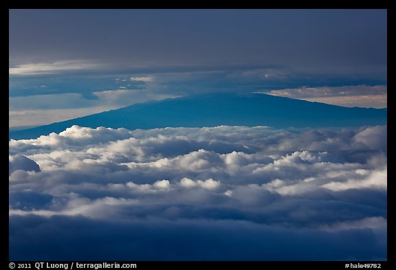 Mauna Kea between clouds, seen from Halekala summit. Haleakala National Park, Hawaii, USA.