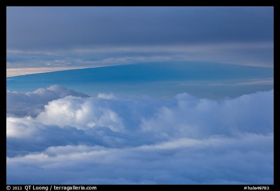 Mauna Loa between clouds, seen from Halekala summit. Haleakala National Park, Hawaii, USA.