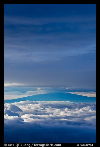 Mauna Kea above and below clouds, sunrise. Haleakala National Park, Hawaii, USA.