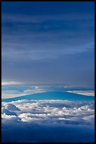 Mauna Kea above and below clouds, sunrise. Haleakala National Park, Hawaii, USA.