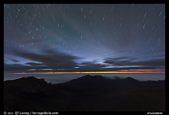 Crater ridge and stars in motion at night. Haleakala National Park, Hawaii, USA.