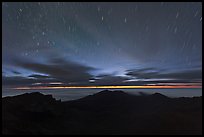 Crater ridge and stars in motion at night. Haleakala National Park, Hawaii, USA. (color)