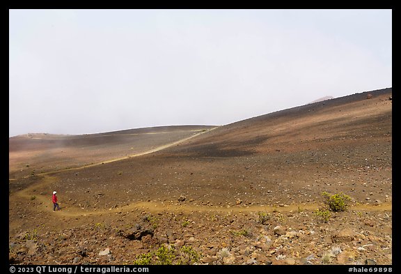 Visitor looking, Haleakala Crater in clouds. Haleakala National Park (color)